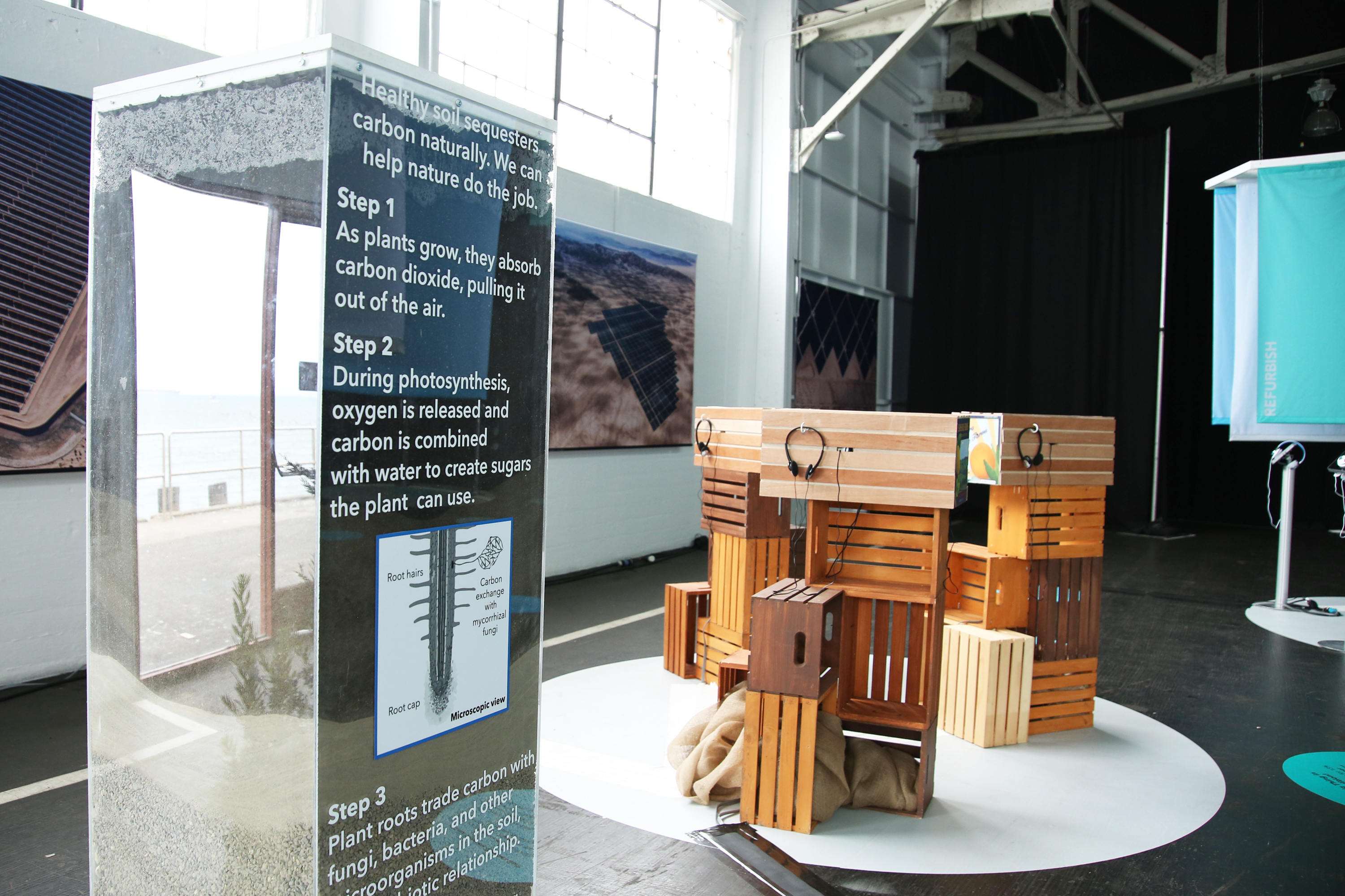 Soil sculpture with graphics and three fruit crates in the background