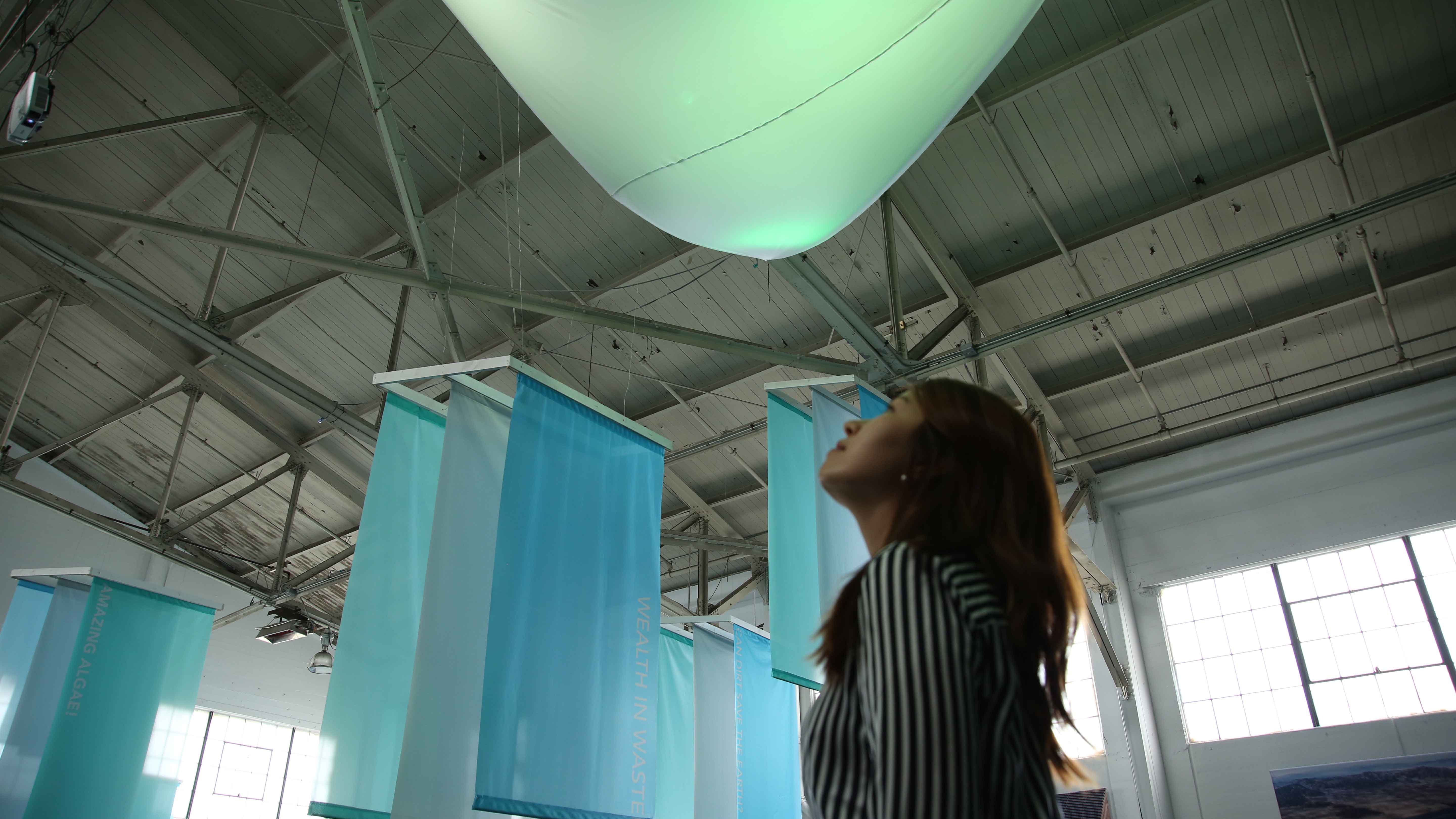 Large, triangular piece of hanging fabric lit up by DMX lights
